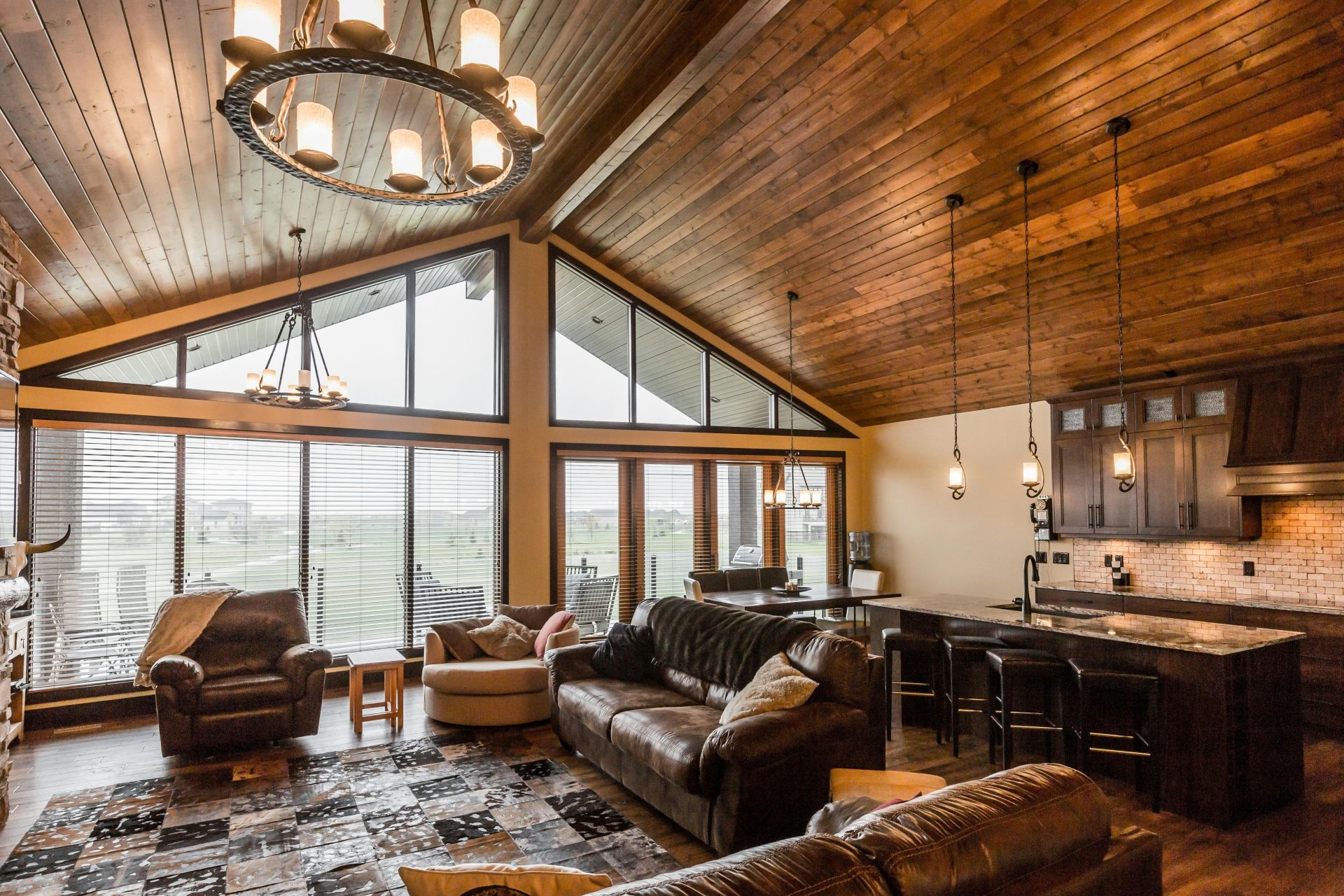 a living room filled with furniture and lots of windows
