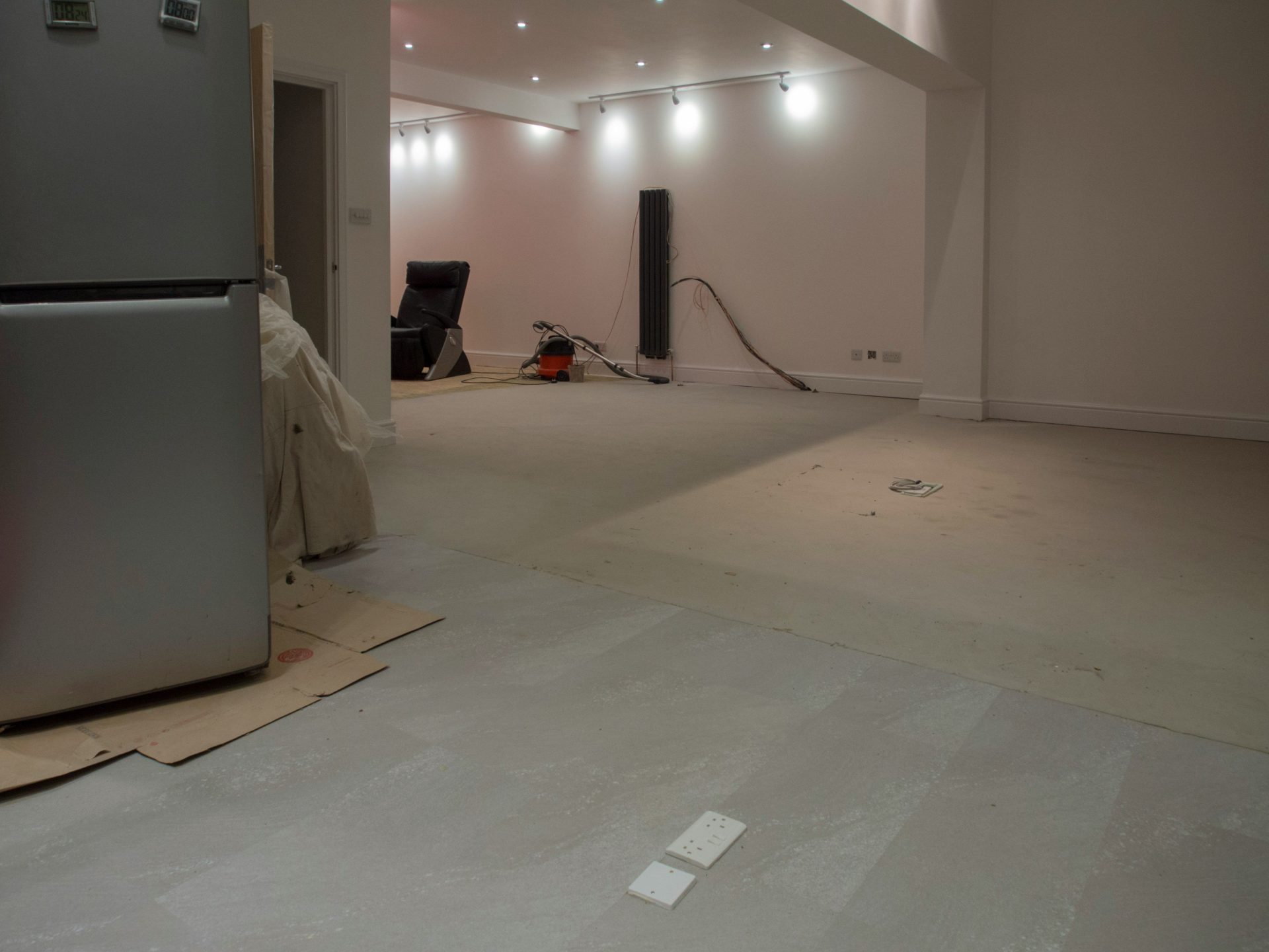 A large, empty room with some appliances.